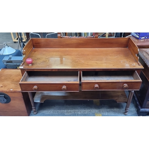 1038 - Star Lot : A lovely Victorian mahogany writing desk with raised back, featuring two drawers and turn... 