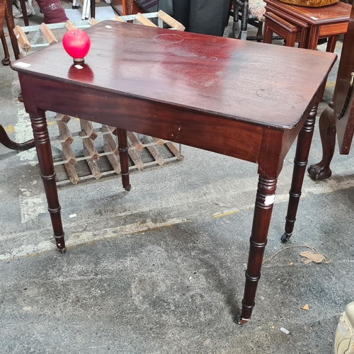 1074 - A handsome early 20th century side table with twisted leg detail and set on castor wheels. From a lo... 