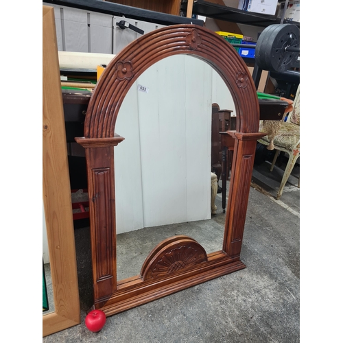 1076 - A wonderful heavy good sized arch shaped wall mirror. Housed in a decoratively carved wooden frame. ... 