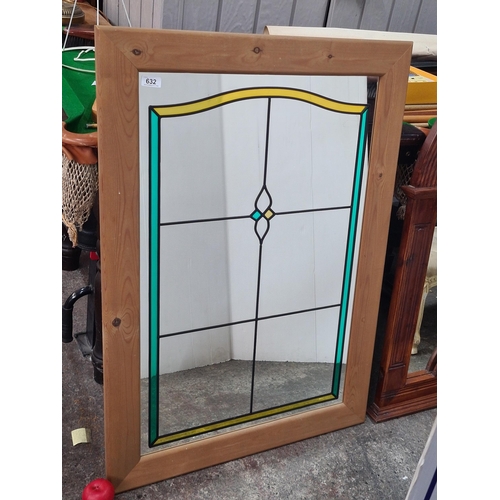 1077 - A tall wall hanging mirror. Features geometric glass painted patterns. Housed in a wooden frame. 
MM... 