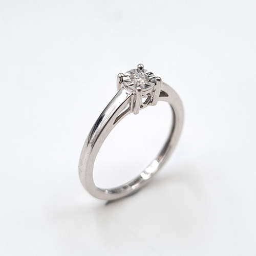 1087 - Star Lot : A fine diamond ring of 0.062 carats set in white gold (375) details stamped to band. In a... 