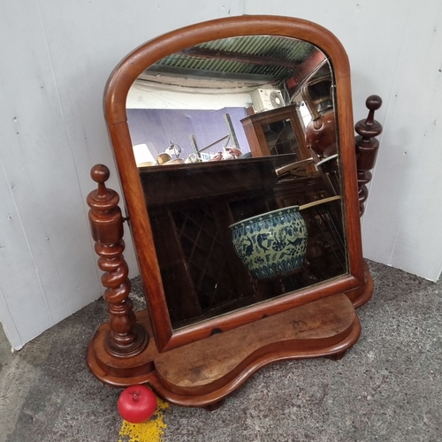 1097 - Victorian mahogany vanity mirror features elegant turned supports and a shaped base.
Previous in auc... 