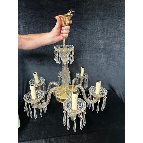 883 - Star lot : A Super chandelier with six arms, gold-tone accents, and adorned with crystal prisms and ... 