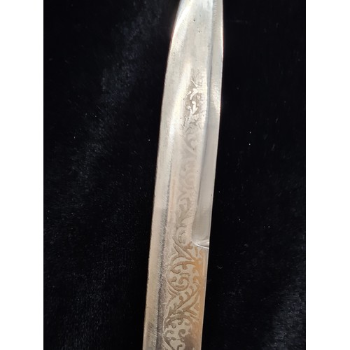 107 - A great example of an Indian talwar sword with a hand guard, etched blade and original sheath.