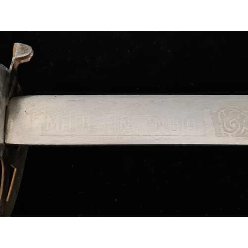 107 - A great example of an Indian talwar sword with a hand guard, etched blade and original sheath.