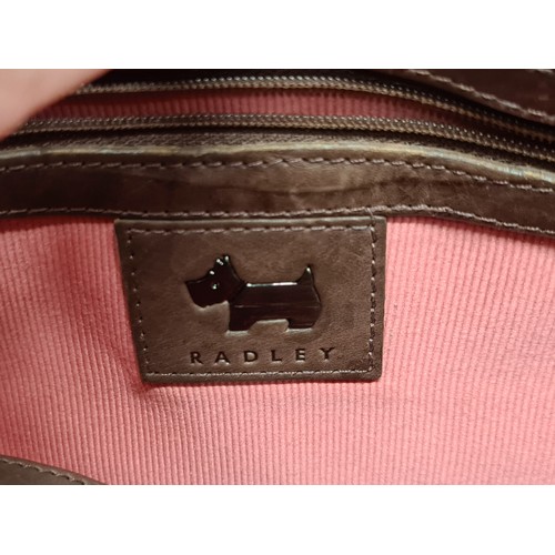 144 - A beautiful ladies brown leather handbag by Radley. In excellent condition. With the classic pink Le... 