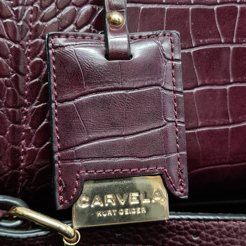 172 - A fabulously stylish ladies Carvela by Kurt Geiger maroon coloured handbag. Complete with long shoul... 