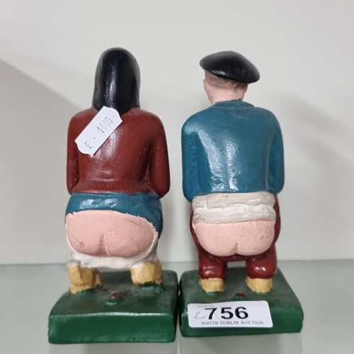 756 - Two chalkware figures reading 