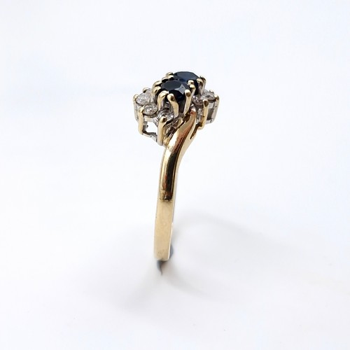 4 - Star lot : A nine carat gold two stone sapphire and diamond ring. Ring size - I 1/2. Weight - 1.7 gr... 