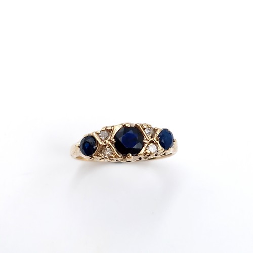 5 - Star Lot : An attractive vintage nine carat gold three stone sapphire & diamond set ring. Size - M 1... 