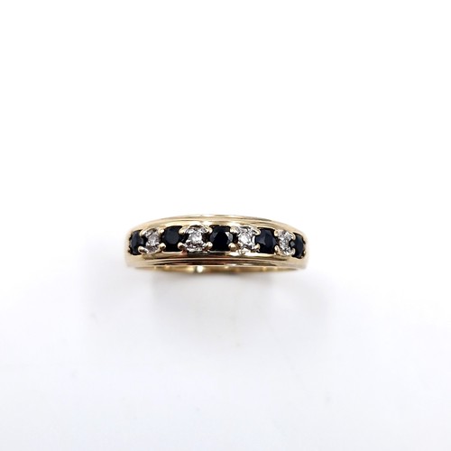 11 - Star Lot : A nine carat gold diamond and sapphire ring. Size - Q. Weight - 2.3 grams.