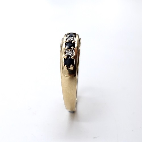 11 - Star Lot : A nine carat gold diamond and sapphire ring. Size - Q. Weight - 2.3 grams.