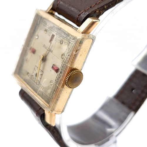 16 - A vintage Bulova wristwatch set with square dial with wind up mechanism and leather strap. Watch in ... 