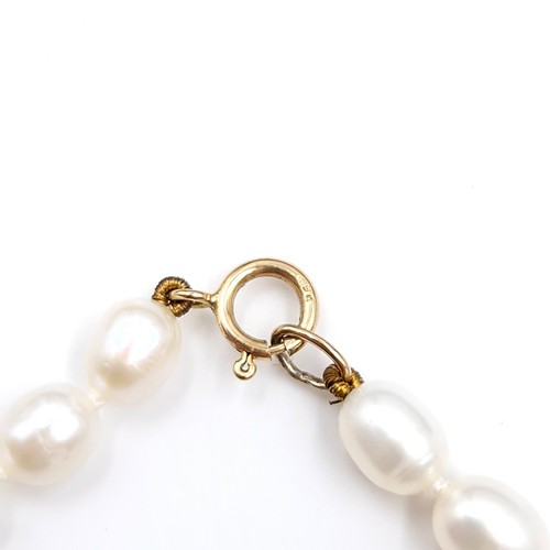 21 - Star Lot : An attractive fresh water pearl necklace set with nine carat gold drop pearl accent with ... 