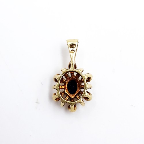 538 - Star Lot : A nine carat gold star design sapphire and diamond stone pendant. Weight 0.94 grams.