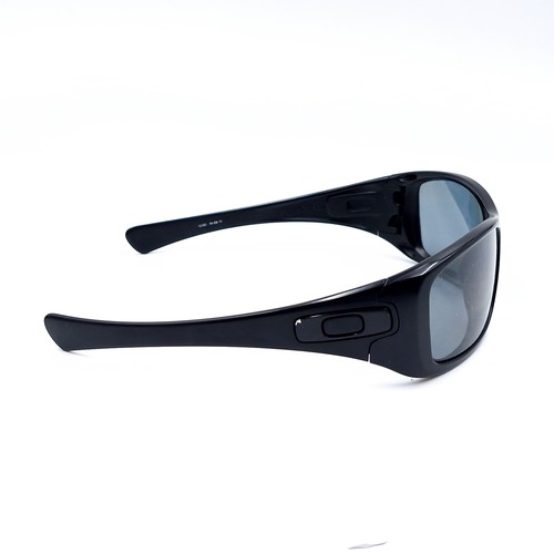 539 - A pair of Oakley Hijinx wrap around sunglasses by Oakley USA marked to frames. Lenses clear.