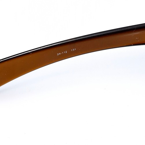 542 - A pair of Oakley wrap around sunglasses with gold tinted frames. Lenses clear.