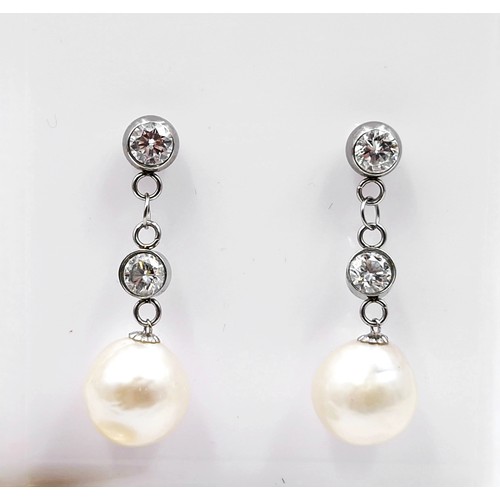 544 - Super Star lot : A pair of 18 carat gold Akoya pearl and diamond earrings. Est. weight of diamond is... 