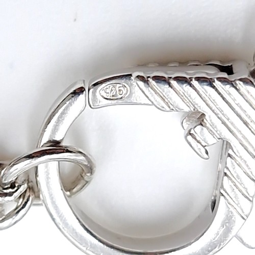 616 - A designer Emporium Armani sterling silver bracelet, with four Armani charms. Set with a chain link ... 