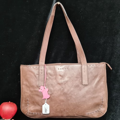 144 - A beautiful ladies brown leather handbag by Radley. In excellent condition. With the classic pink Le... 