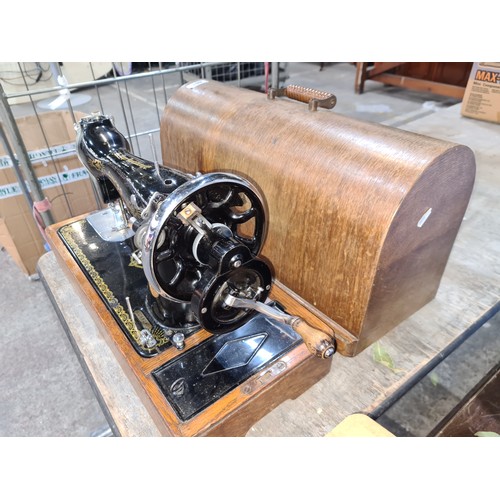 461 - Vintage Singer oak sewing machine with case and handle.