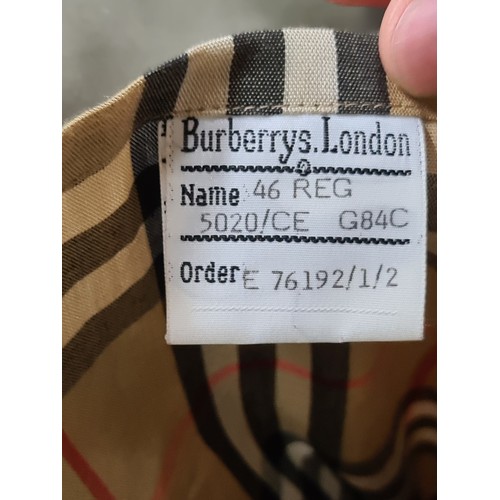 790 - Star lot : A Burberry's of London designer men's trench coat with belt and classic check lining. Ver... 