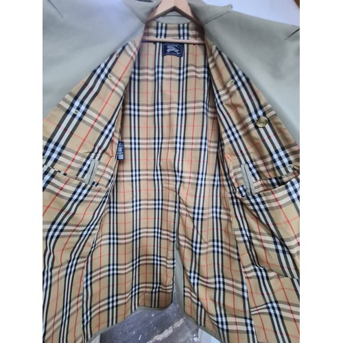 790 - Star lot : A Burberry's of London designer men's trench coat with belt and classic check lining. Ver... 