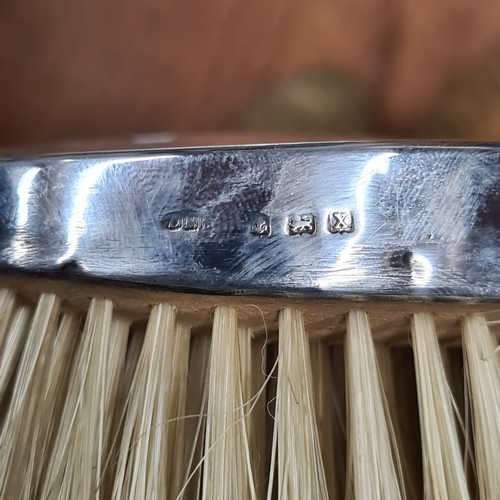 822 - A lot of three sterling silver case brushes including two hair brushes and one clothes brush. All ha... 