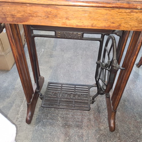 708 - A wonderful antique Singer sewing machine complete with work table and drawers.