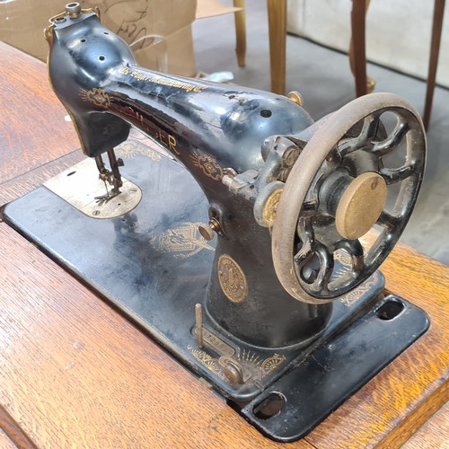 708 - A wonderful antique Singer sewing machine complete with work table and drawers.