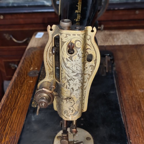 708 - A wonderful antique Singer sewing machine complete with work table and drawers.