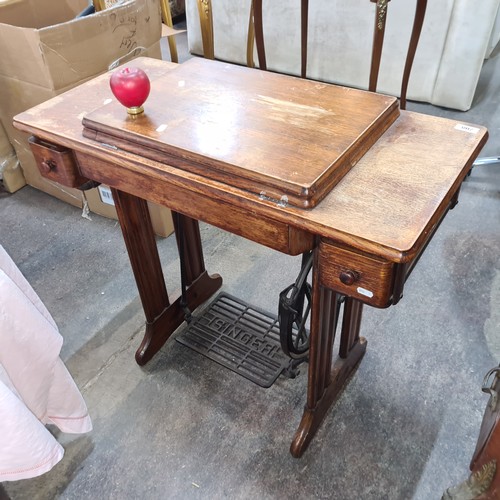 708 - A wonderful antique Singer sewing machine complete with work table and drawers.