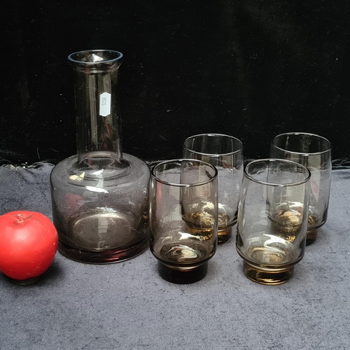 213 - A super 1960's decanter and matching tumbler glasses with sticker marked 