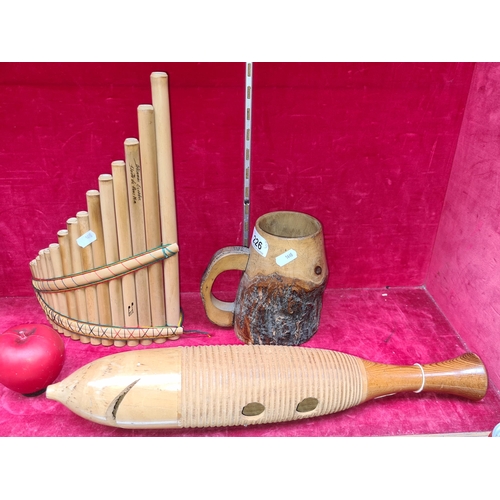 226 - A mixed lot including a hand crafted wooden mug with applied handle, a handmade pan flute with inscr... 