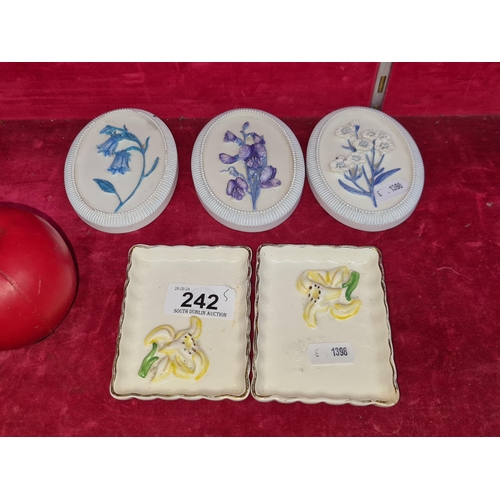 242 - Two very pretty Wedgwood pin dishes along with a trio of dainty wall plaques with wildflower designs... 