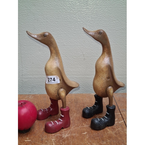 274 - A pair of Charming heavy cast metal sculptures of ducks in elongated form with whimsical red and bla... 