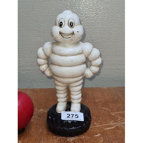 275 - An iconic Michelin Man cast iron coin bank.