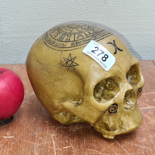 278 - A sculpture of a human skull featuring detailed zodiac signs and traditional Irish festivals.