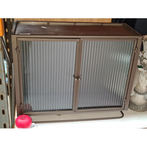 290 - A  steal cabinet featuring reeded glass panels and double doors to front. Brand new from a top Uk de... 