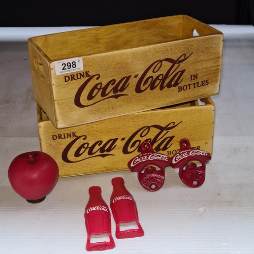 298 - Six Coca Cola branded items including two crates and four cast metal bottle openers.