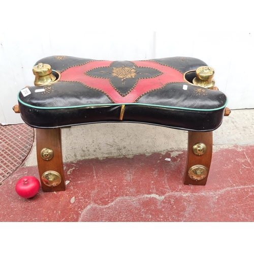 310 - A fabulous vintage camel stool with leather seat and brass hardware.