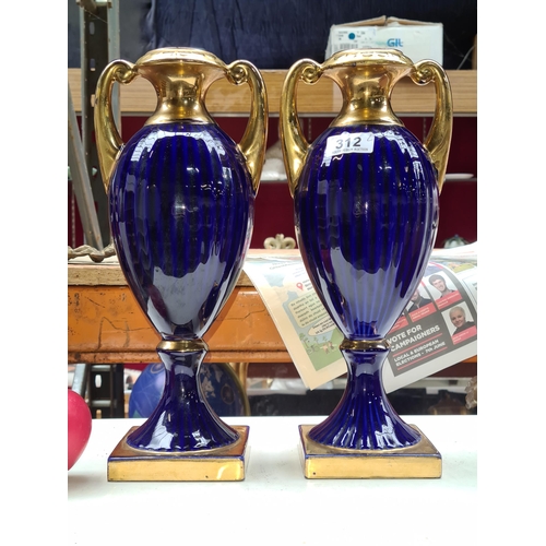 312 - A pair of Italian made ceramic twin handled urn shaped vases in cobalt blue with gold accents mounte... 