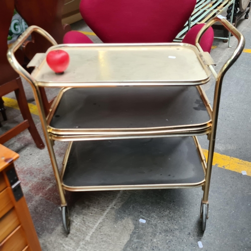 329 - A vintage three tier trolley in a nice gold toned finish with perforated shelves and removable top t... 