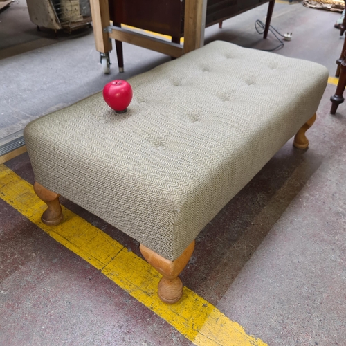 345 - A footed button back ottoman / foot stool upholstered in the classic herringbone pattern featuring c... 