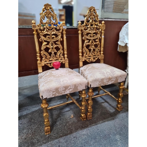 374 - Star Lot : A pair of Gilt French style hall chairs with heavily gilded and decorative carved timber ... 