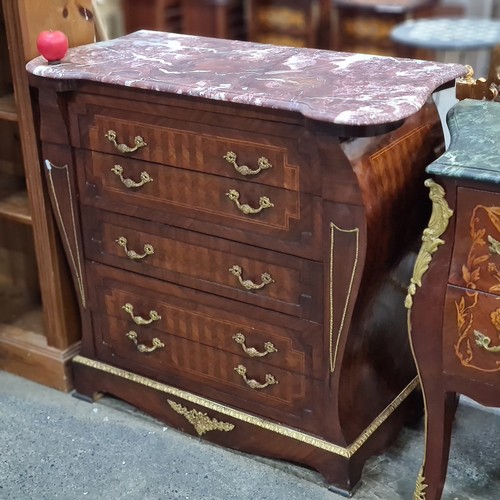 385 - Star Lot : A striking French style chest of drawers boasting beautiful marquetry detail, gilt accent... 