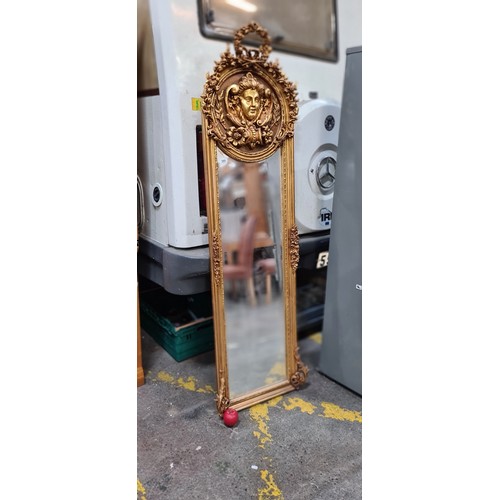 389 - Star Lot : A gorgeous and very elegant tall French gold gilt bevelled mirror. With Female mask detai... 