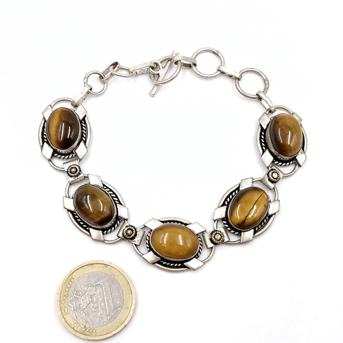 12 - A pretty vintage sterling silver five panel tiger's eye stone bracelet set with T-bar clasp. Weight ... 