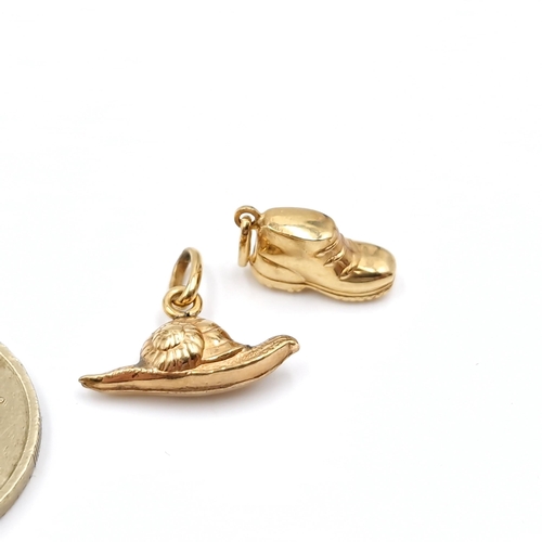 22 - Two 18 carat gold charms in the form of a boot & a snail. Total weight - 1.8 grams.