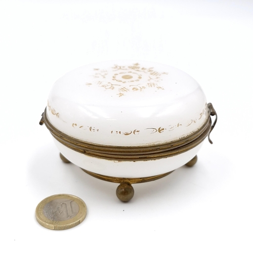 28 - A 19th century French Opaline glass hand-painted gilded box standing on four ball feet with hinged l... 